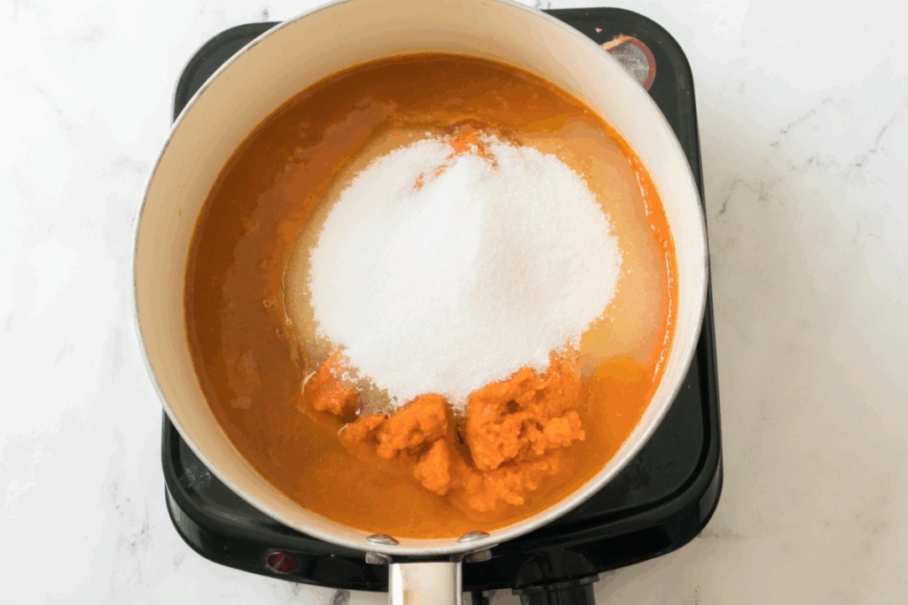 A close-up of a person's face with a hint of pumpkin butter smeared gently across their cheek.