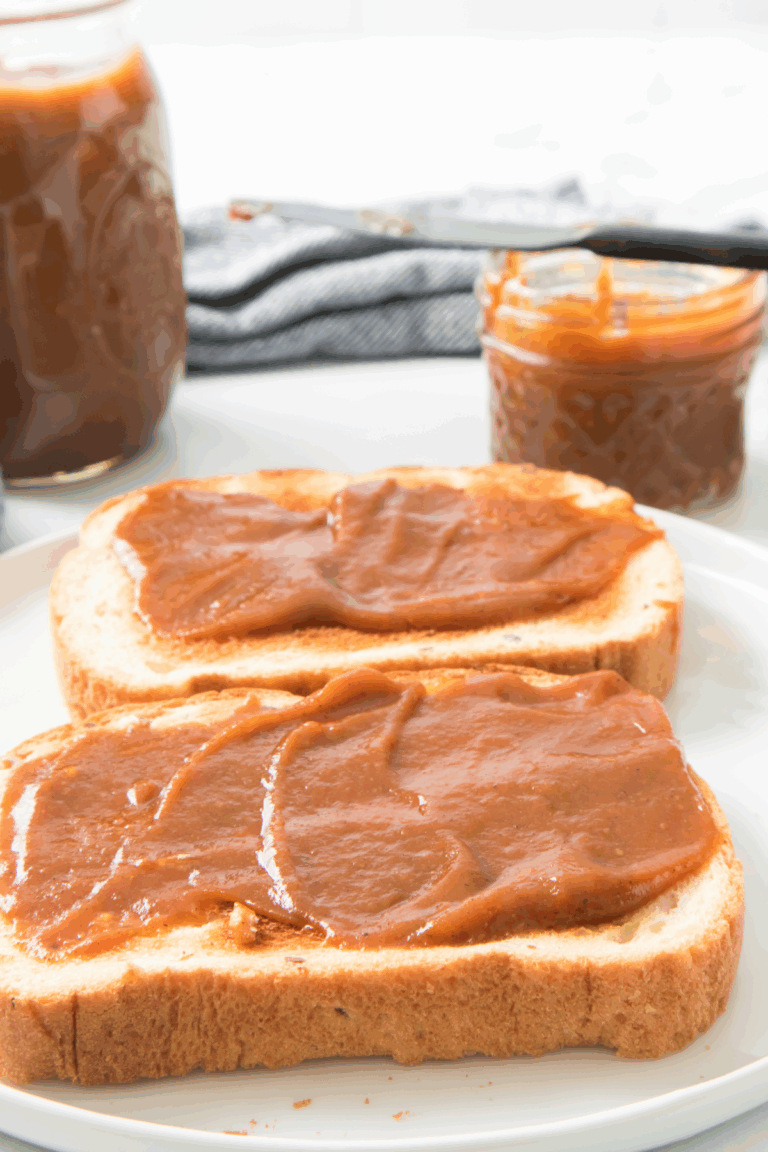A plate of toast with a generous layer of pumpkin butter spread on it.